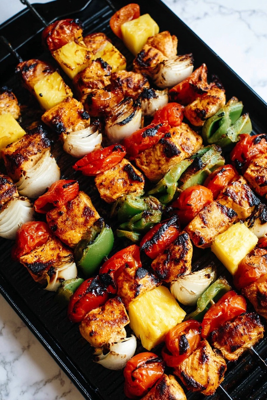 The image shows six skewers of grilled kebabs arranged diagonally on a black grill pan. Each skewer has five main layers repeated in this order: charred golden-brown chicken pieces with slightly burnt edges, bright red tomato slices, white onion chunks with a bit of brown from grilling, green bell pepper slices with soft edges, and yellow pineapple cubes with grill marks. The layers alternate evenly on each skewer, with each piece looking juicy and cooked. The background is a white marbled surface that contrasts with the dark grill and colorful food. photo taken with an iphone --ar 2:3 --v 7
