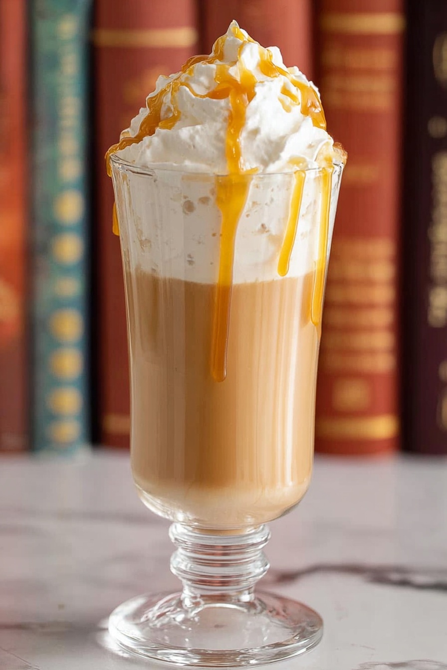 Two clear glass mugs filled with three layers: the bottom layer is light brown coffee, the middle layer is thick white cream, and the top layer is a large fluffy mound of white whipped cream drizzled with golden caramel sauce. The mugs are set on a white marbled surface, and in the background, there are two yellowish Harry Potter books stacked with a dark brown wand resting on top. Photo taken with an iphone --ar 2:3 --v 7