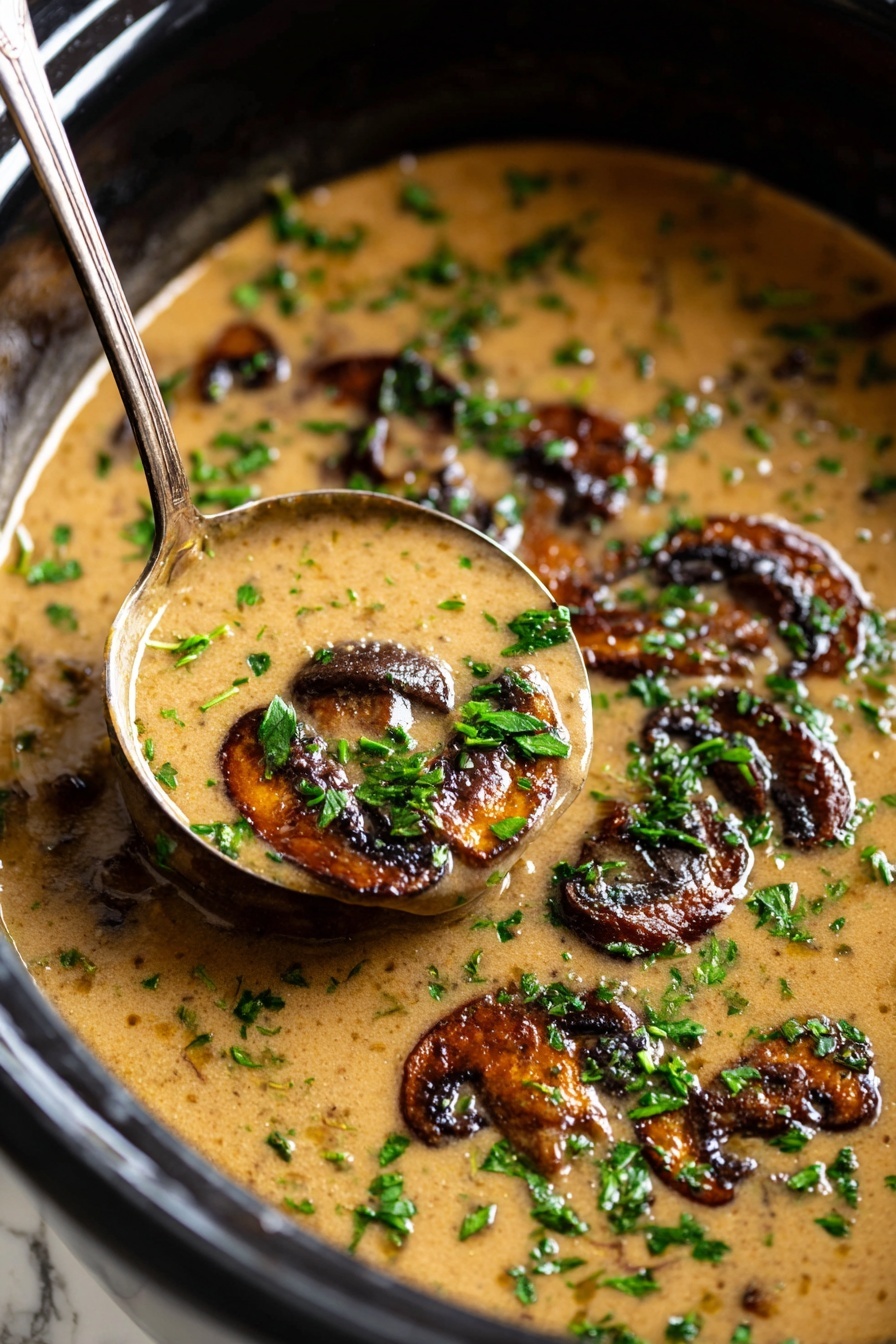 A ceramic bowl filled with a thick, smooth orange-brown soup, topped with several dark brown, roasted mushroom slices scattered across the surface. The mushrooms have a shiny, slightly crisp texture with some seasoning visible. Finely chopped green herbs are sprinkled both on the soup and around the bowl, adding a fresh contrast. A golden spoon rests inside the bowl, partially submerged in the soup, on a white marbled surface with a white cloth next to it, and copper containers in the background. Photo taken with an iphone --ar 2:3 --v 7