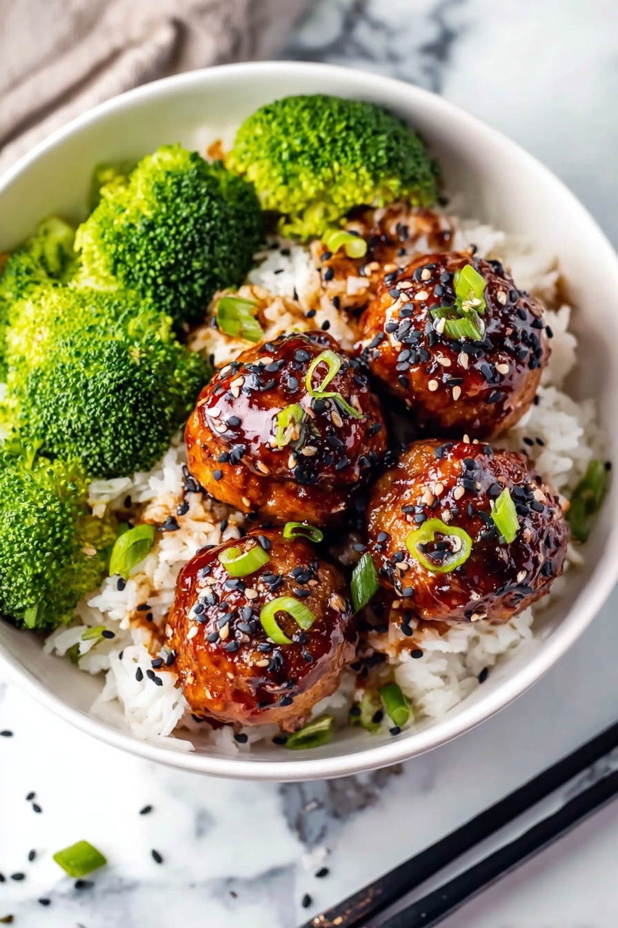 A white bowl filled with a base layer of white rice with a soft texture, topped by five shiny, round meatballs glazed with a dark brown sauce, sprinkled with black and white sesame seeds and small chopped green onion pieces. On one side of the bowl, there is a bright green layer of fresh broccoli florets with a slightly rough texture. The bowl sits on a white marbled surface with black chopsticks resting next to it. photo taken with an iphone --ar 2:3 --v 7