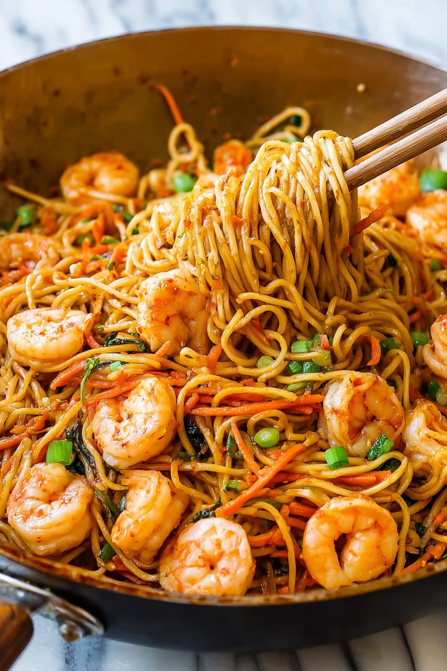 A close-up view inside a pan filled with stir-fried noodles and shrimp. The dish has three main layers: at the bottom, golden brown noodles mixed with thin orange carrot strips and small bright green pieces of green onion; on top, plump, light orange shrimp scattered evenly; and mixed throughout, tiny bits of dark green herbs. Wooden chopsticks are lifting a portion of the noodles and carrots from the pan. The background shows a white marbled texture. Photo taken with an iphone --ar 2:3 --v 7