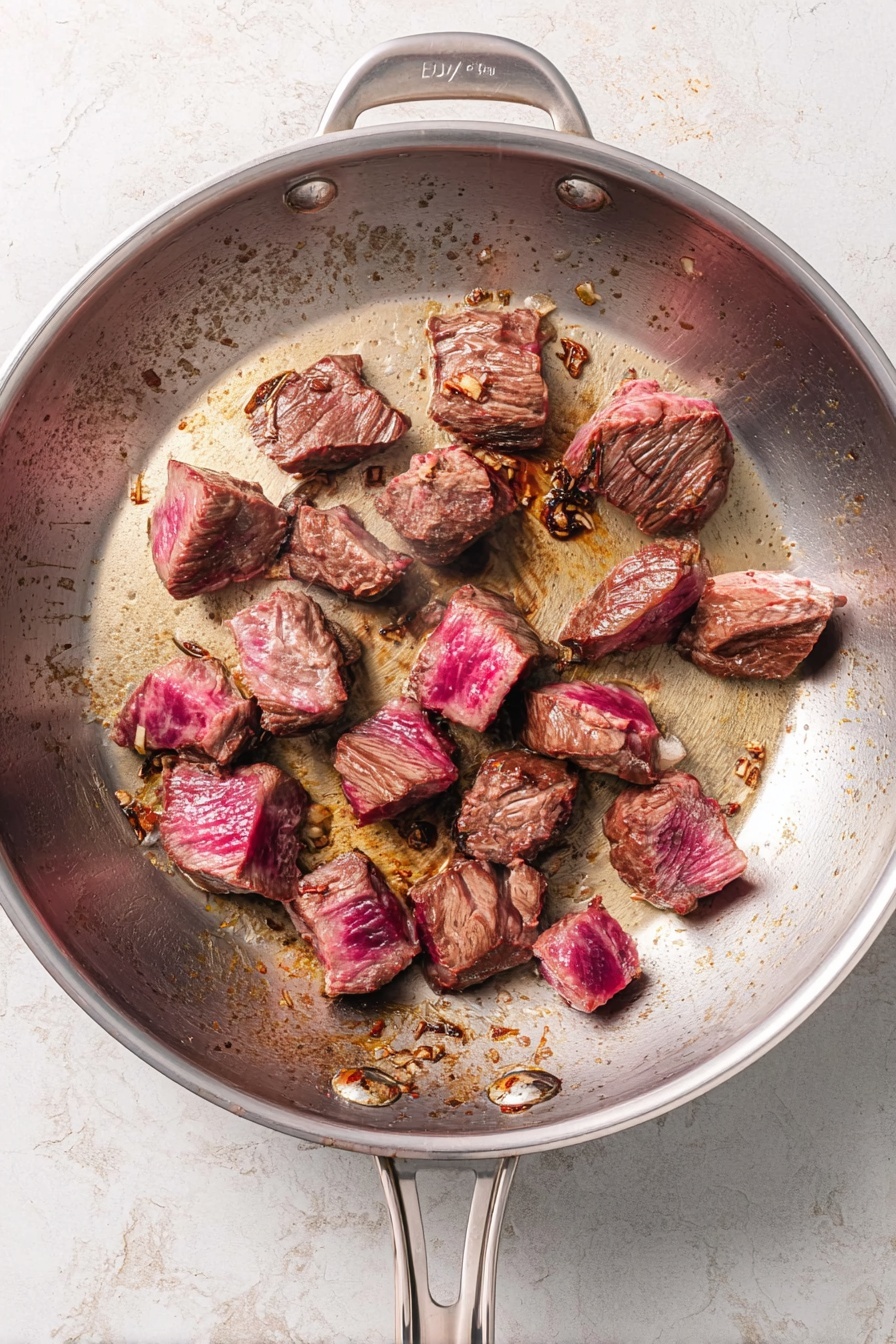 The image shows a white round bowl held by woman's hands, filled with three layers of food. The bottom layer is creamy white mashed potatoes, the middle layer consists of dark brown chunks of beef with thick brown gravy covering most of the mashed potatoes, and the top layer on one side is bright orange cooked baby carrots sprinkled with small green parsley pieces. The bowl is resting on a white marbled surface with some fresh green parsley scattered around. Photo taken with an iphone --ar 2:3 --v 7