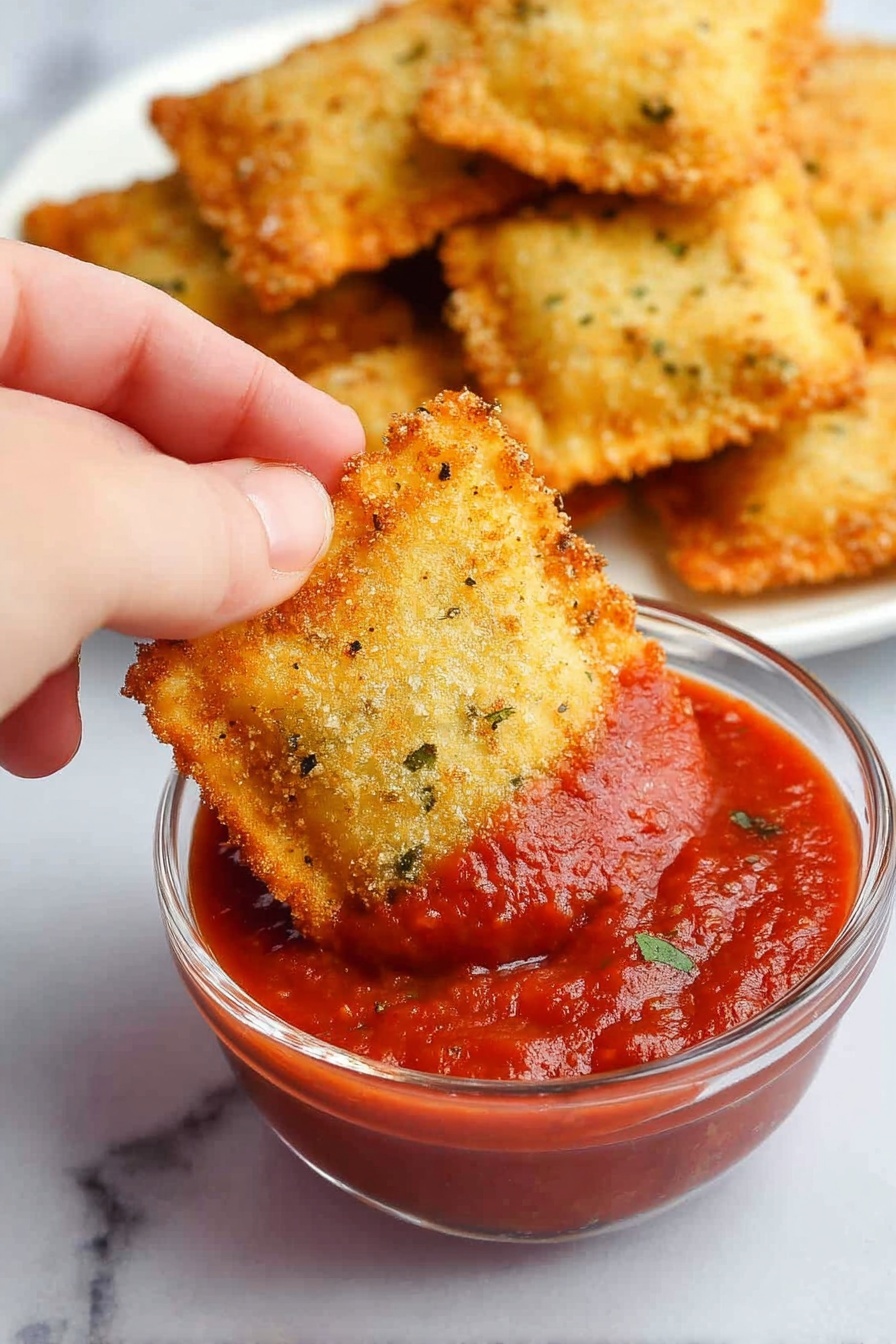 The image shows a tray with eight round ravioli pieces arranged in two columns, four in each row, placed on white parchment paper. Each ravioli has a light golden yellow pasta base wrapped around a filling, covered with a thick layer of pale brown bread crumbs with small dark specks, giving a textured, somewhat rough surface. The edges of the ravioli are crimped in a scalloped pattern. The tray is dark metal and contrasts with the white parchment paper beneath. The background is a white marbled surface. photo taken with an iphone --ar 2:3 --v 7