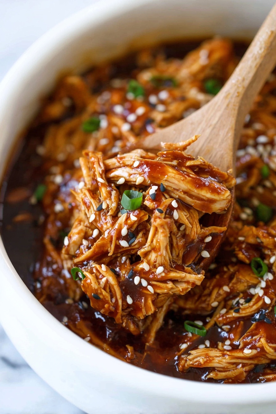 A close-up view of shredded orange-brown chicken soaked in a thick, shiny dark sauce inside a white bowl, with small white and black sesame seeds sprinkled on top along with chopped green onion bits, a wooden spoon lifting a portion of the chicken showing tender and fibrous texture, all set against a white marbled background. photo taken with an iphone --ar 2:3 --v 7